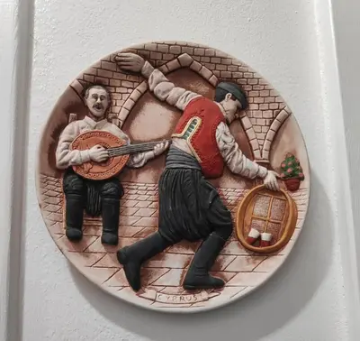 a plate with two baseball players on a wall at Little Paradise in Sotira