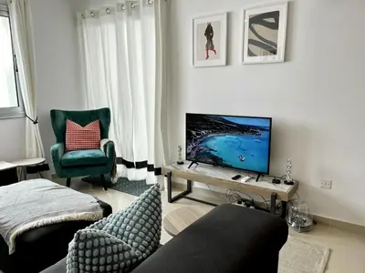 a living room with a couch and a television at STAY Chromata Lagoon Apartment in Protaras