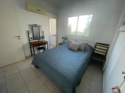 a bedroom with a bed and a mirror and a desk at Atlantis Court in Makenzy in Larnaka