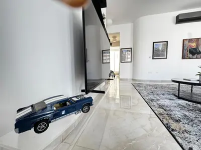 a room with a model of a blue car on a wall at Wealthystays Premium Residence in Nicosia