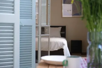 a bedroom with a bed with a book shelf in it at Gladstone Apartment by Tangerine in Nicosia