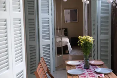 a dining room with a table with a vase of flowers at Gladstone Apartment by Tangerine in Nicosia