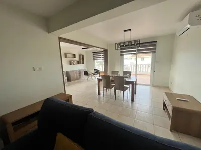 a living room with a couch and a table at Trinity Blue Apt in Paralimni