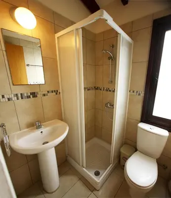 a bathroom with a shower and a sink and a toilet at The Bay Villa in Pissouri