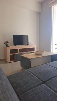 a living room with a tv and a table at Obv 3206 in Pyla