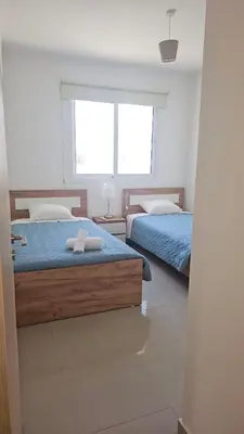 a bedroom with two beds and a window at Obv 3206 in Pyla