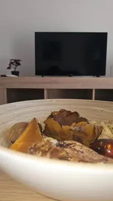 a white plate of food on a wooden table at Obv 3206 in Pyla