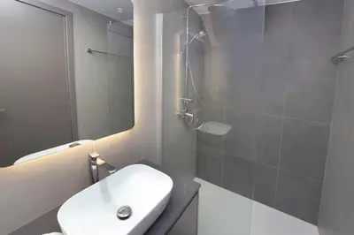 a bathroom with a sink and a toilet and a shower at Sun and Moon Luxury Villas Ayia Napa in Ayia Napa