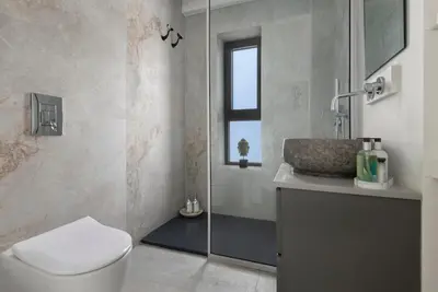 a bathroom with a toilet and a sink and a shower at Luxury Beachfront Apartment in Limassol