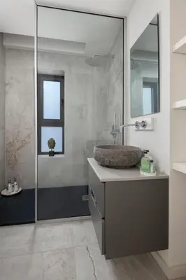 a bathroom with a sink and a mirror at Luxury Beachfront Apartment in Limassol