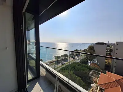 a view of the ocean from a balcony at Luxury Beachfront Apartment in Limassol