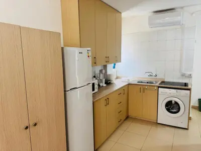 a kitchen with a white refrigerator and a dishwasher at Marielenas in Larnaka