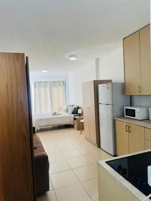 a kitchen with a refrigerator and a couch in a room at Marielenas in Larnaka