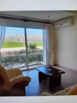a living room with a couch and a table and a large window at Beautiful 1-Bed House in Aglantzia