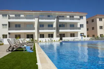 a swimming pool in front of a building at Mythical Sands - Saltos in Paralimni