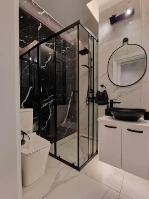 a bathroom with a glass shower and a toilet at 3 rooms modern apartment close to the beach! in Larnaka