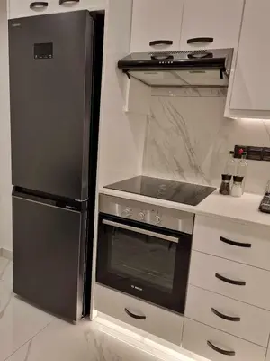 a kitchen with a stove and a refrigerator at 3 rooms modern apartment close to the beach! in Larnaka