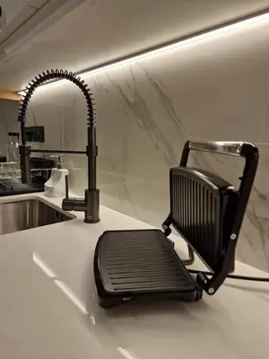 a black chair sitting on a counter next to a sink at 3 rooms modern apartment close to the beach! in Larnaka