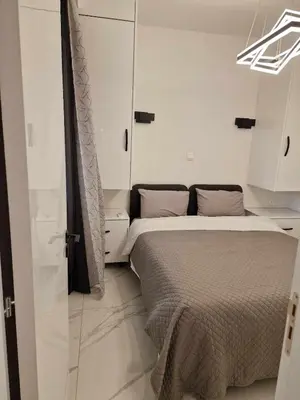 a bedroom with a bed and a sliding glass door at 3 rooms modern apartment close to the beach! in Larnaka