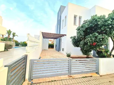 a white house with a gate and a fence at Luxury Villa Azure in Larnaka