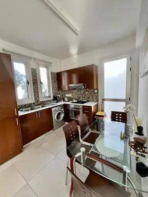 a large kitchen with a glass table and chairs at Luxury Villa Azure in Larnaka