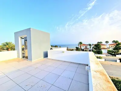a white house with a view of the ocean at Luxury Villa Azure in Larnaka