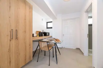 a kitchen with a table and a counter top at Finikoudes Marina View 202 in Larnaka