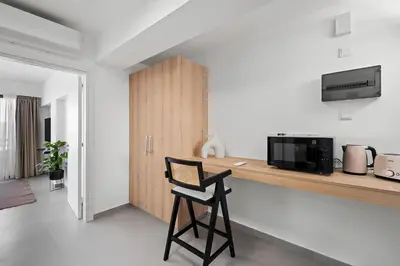 a black chair sitting at a counter in a kitchen at Finikoudes Marina View 202 in Larnaka