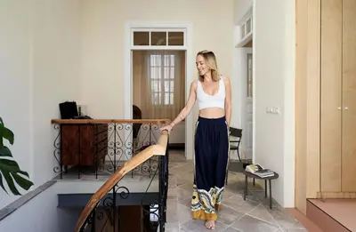 a woman standing on a balcony holding a bat at Timeless Gem in Old Nicosia in Nicosia
