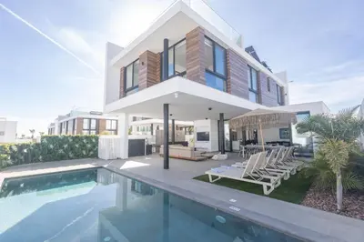 a villa with a swimming pool and a house at Protaras Aqua Pearl Villa AQ18 in Protaras