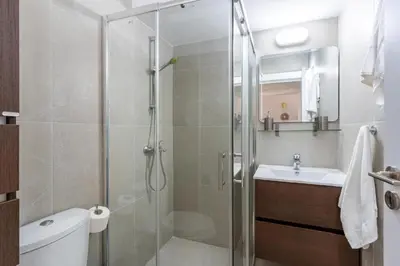 a bathroom with a shower and a toilet and a sink at Lazy River 1-Bedroom Apartment in Larnaka