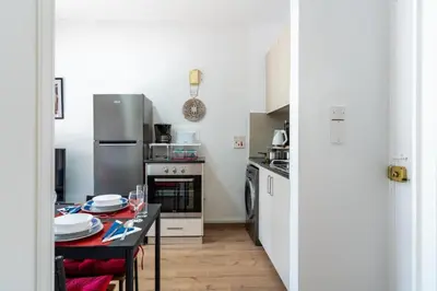 a kitchen with a table with plates on it at Lazy River 1-Bedroom Apartment in Larnaka