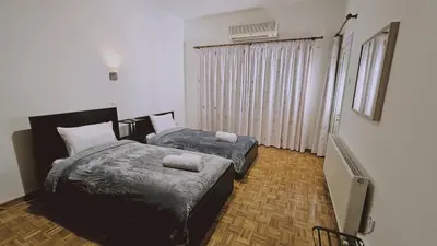 a bedroom with two beds with towels on them at STAY Aurum Apartment in Nicosia
