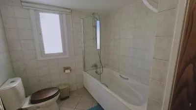 a bathroom with a toilet and a tub and a sink at STAY Aurum Apartment in Nicosia