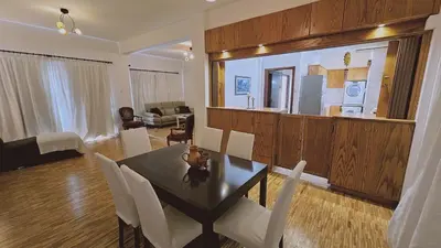 a dining room and living room with a table and chairs at STAY Aurum Apartment in Nicosia
