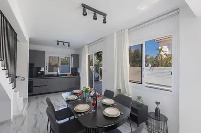 a dining room with a table and chairs at Mandali Villa 20 - Fully Renovated Villa in Paralimni