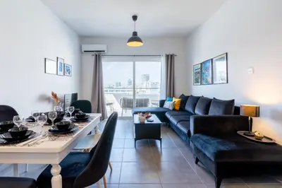 a living room with a couch and a table at Snobby 2-Bedroom Apartment in Larnaka