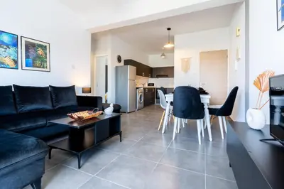 a living room with a couch and a table at Snobby 2-Bedroom Apartment in Larnaka