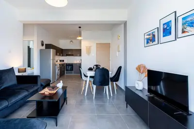 a living room with a couch and a table at Snobby 2-Bedroom Apartment in Larnaka