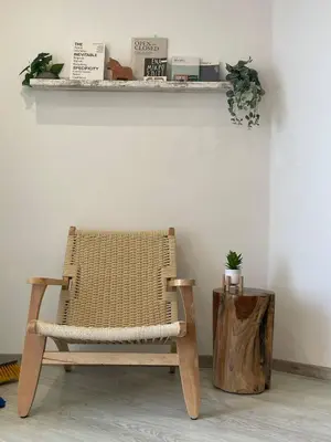 a rattan chair sitting on a wall with a shelf at Seaview City Retreat in Larnaka