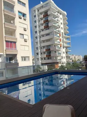 a swimming pool in front of two tall buildings at Seaview City Retreat in Larnaka