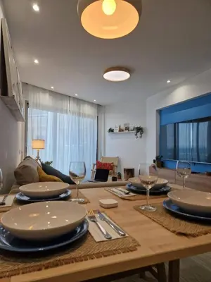 a dining room table with plates and wine glasses at Seaview City Retreat in Larnaka