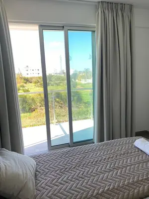 a bedroom with a bed and a large window at Apartment Lorena Protaras in Protaras