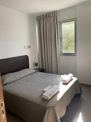 a bedroom with a bed with two towels on it at Apartment Lorena Protaras in Protaras