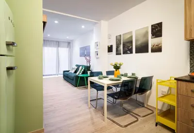 a kitchen and living room with a table and a couch at Beach Walk - Central, Cool, Cute, Convenient in Limassol