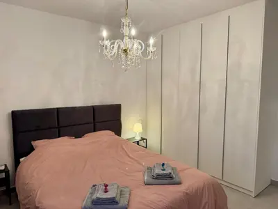 a bedroom with a bed with two towels on it at Brandnew Rooftop Flat near Larnaca Mall in Larnaka