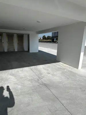 a shadow of a person taking a picture of a building at Brandnew Rooftop Flat near Larnaca Mall in Larnaka