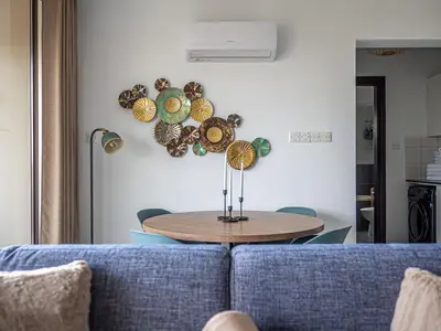a table in a living room with a blue couch at Cozy sea view Apartment in Mazotos