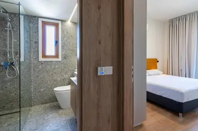 a bathroom with a bed a toilet and a shower at Stylish Central Apartment • City Views • Prime Location • Parking in Nicosia