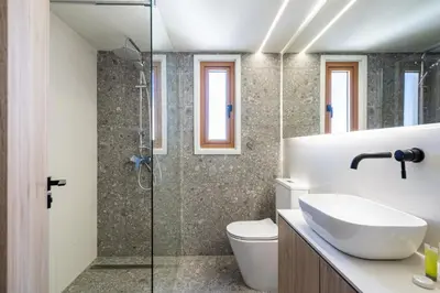 a bathroom with a shower and a toilet and a sink at Stylish Central Apartment • City Views • Prime Location • Parking in Nicosia